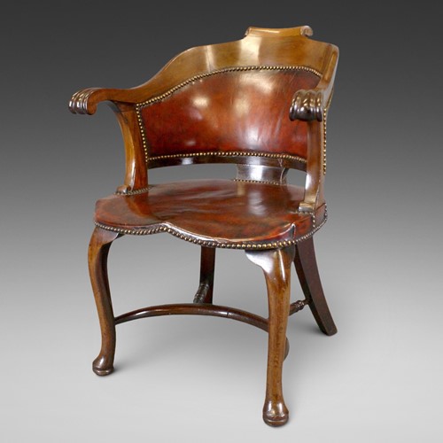 A Walnut And Leather Arm Chair