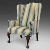 A 19th century walnut wing chair