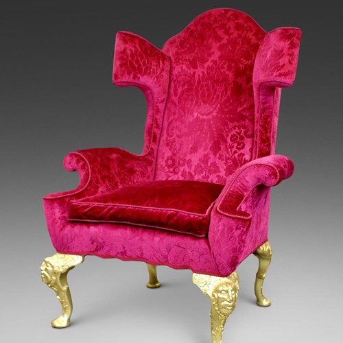 An Extravagant Carved Giltwood Wing Chair