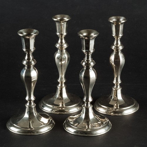 A Set Of Four Seamed Candlesticks